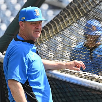 Jun 14, 2025; Omaha, Neb, USA;  UCLA Bruins head coach John Savage watches the team warm up before the game against the Murray State Races at Charles Schwab Field. Mandatory Credit: Steven Branscombe-Imagn Images