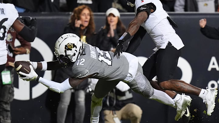 Oct 26, 2024; Boulder, Colorado, USA; Colorado Buffaloes wide receiver Travis Hunter (12) dives for a touchdown in the second quarter against the Cincinnati Bearcats at Folsom Field. Mandatory Credit: Ron Chenoy-Imagn Images