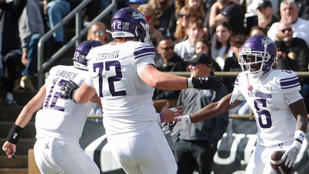 Northwestern Wildcats running back Joseph Himon II (6) celebrates with Northwestern Wildcats quarterback Jack Lausch (12) and Northwestern Wildcats offensive lineman Caleb Tiernan (72) after scoring Saturday, Nov. 2, 2024, during the NCAA football game against the Purdue Boilermakers at Ross-Ade Stadium in West Lafayette, Ind. Northwestern Wildcats running back Joseph Himon II (6) celebrates with Northwestern Wildcats quarterback Jack Lausch (12) and Northwestern Wildcats offensive lineman Caleb Tiernan (72) after scoring Saturday, Nov. 2, 2024, during the NCAA football game against the Purdue Boilermakers at Ross-Ade Stadium in West Lafayette, Ind.