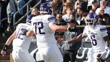 Northwestern Wildcats running back Joseph Himon II (6) celebrates with Northwestern Wildcats quarterback Jack Lausch (12) and Northwestern Wildcats offensive lineman Caleb Tiernan (72) after scoring Saturday, Nov. 2, 2024, during the NCAA football game against the Purdue Boilermakers at Ross-Ade Stadium in West Lafayette, Ind.