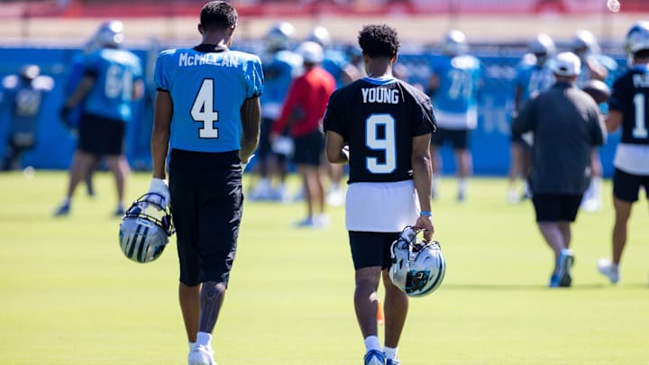Jul 26, 2025; Charlotte, NC, USA; Carolina Panthers wide receiver Tetairoa McMillan (4) and quarterback Bryce Young (9) talk as they head to stretch during training camp. 