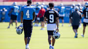 Jul 26, 2025; Charlotte, NC, USA; Carolina Panthers wide receiver Tetairoa McMillan (4) and quarterback Bryce Young (9) talk as they head to stretch during training camp. 