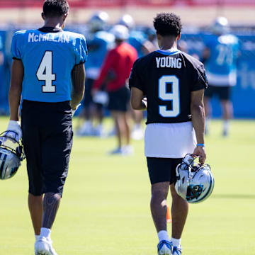 Jul 26, 2025; Charlotte, NC, USA; Carolina Panthers wide receiver Tetairoa McMillan (4) and quarterback Bryce Young (9) talk as they head to stretch during training camp. 