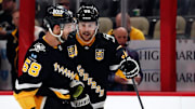 Feb 18, 2024; Pittsburgh, Pennsylvania, USA;  Pittsburgh Penguins defenseman Kris Letang (58) listens to fellow defenseman Erik Karlsson (65) against the Los Angeles Kings during the third period at PPG Paints Arena. Mandatory Credit: Charles LeClaire-Imagn Images
