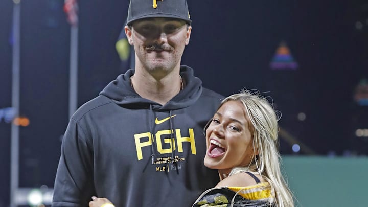 Pittsburgh Pirates starting pitcher Paul Skenes (30) poses with his girlfriend Louisiana State University gymnast Olivia Dunn (right) after making his major league debut against the Chicago Cubs.