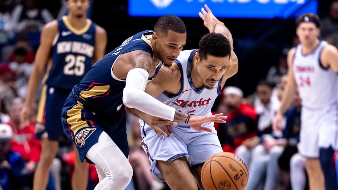 Jan 3, 2025; New Orleans, Louisiana, USA;  New Orleans Pelicans guard Dejounte Murray (5) steals the ball from Washington Wizards guard Malcolm Brogdon (15) during the second half at Smoothie King Center. Mandatory Credit: Stephen Lew-Imagn Images