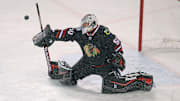 Mar 1, 2014; Chicago, IL, USA; Chicago Blackhawks goalie Corey Crawford (50) makes a save during the third period against the Pittsburgh Penguins in a Stadium Series hockey game at Soldier Field. Chicago won 5-1. Mandatory Credit: Dennis Wierzbicki-Imagn Images