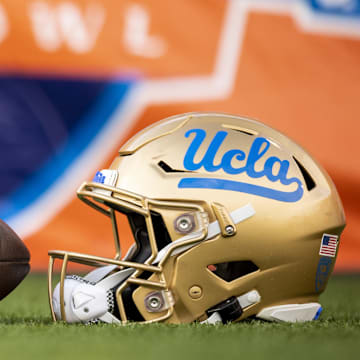 Dec 30, 2022; El Paso, Texas, USA; Helmets of the Pittsburgh Panthers and UCLA Bruins are posed in front of the logo before the 2022 Sun Bowl at Sun Bowl. Mandatory Credit: Ivan Pierre Aguirre-Imagn Images