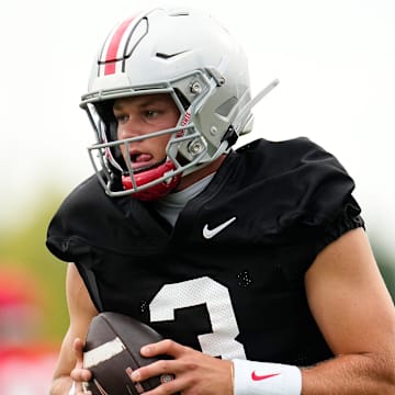 Ohio State Buckeyes quarterback Lincoln Kienholz (3) takes a snap during the first football practice of the season at the Woody Hayes Athletic Center on July 31, 2025.
