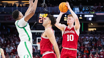 Mar 13, 2025; Indianapolis, IN, USA; Indiana Hoosiers forward Luke Goode (10) shoots the ball while Oregon Ducks guard TJ Bamba (5) defends in the first half at Gainbridge Fieldhouse. Mandatory Credit: Trevor Ruszkowski-Imagn Images