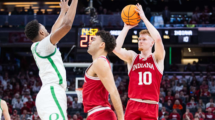 Mar 13, 2025; Indianapolis, IN, USA; Indiana Hoosiers forward Luke Goode (10) shoots the ball while Oregon Ducks guard TJ Bamba (5) defends in the first half at Gainbridge Fieldhouse. Mandatory Credit: Trevor Ruszkowski-Imagn Images