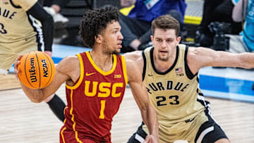 Mar 13, 2025; Indianapolis, IN, USA; USC Trojans guard Desmond Claude (1) passes the ball while Purdue Boilermakers forward Camden Heide (23) defends in the second half at Gainbridge Fieldhouse. Mandatory Credit: Trevor Ruszkowski-Imagn Images