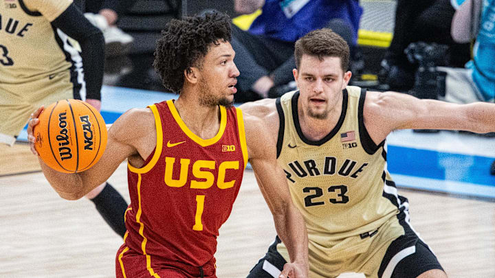 Mar 13, 2025; Indianapolis, IN, USA; USC Trojans guard Desmond Claude (1) passes the ball while Purdue Boilermakers forward Camden Heide (23) defends in the second half at Gainbridge Fieldhouse. Mandatory Credit: Trevor Ruszkowski-Imagn Images