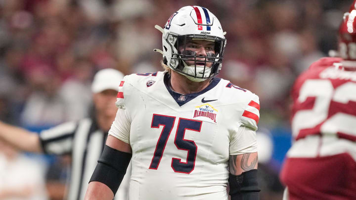 Dec 28, 2023; San Antonio, TX, USA;  Arizona Wildcats offensive lineman Josh Baker (75) gets ready for a play in the first half against the Oklahoma Sooners at Alamodome