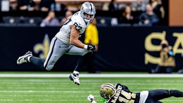 Dec 29, 2024; New Orleans, Louisiana, USA;  Las Vegas Raiders tight end Michael Mayer (87) leaps to avoid the tackle of New Orleans Saints cornerback Kool-Aid McKinstry (14) during the second half at Caesars Superdome. 