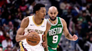 Jan 31, 2025; New Orleans, Louisiana, USA; New Orleans Pelicans guard Trey Murphy III (25) dribbles against Boston Celtics guard Derrick White (9) during the second half at Smoothie King Center. 