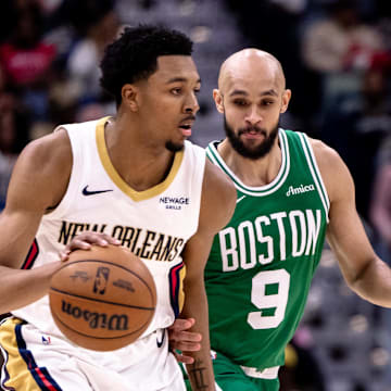 Jan 31, 2025; New Orleans, Louisiana, USA; New Orleans Pelicans guard Trey Murphy III (25) dribbles against Boston Celtics guard Derrick White (9) during the second half at Smoothie King Center. 