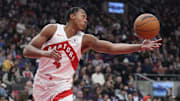 Mar 10, 2025; Toronto, Ontario, CAN; Toronto Raptors guard Scottie Barnes (4) reaches for a ball against the Washington Wizards during the first half at Scotiabank Arena. Mandatory Credit: John E. Sokolowski-Imagn Images