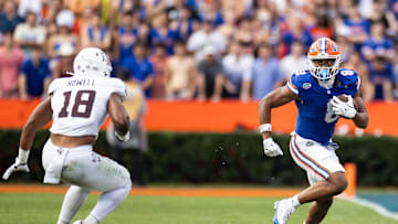 Sep 14, 2024; Gainesville, Florida, USA; Florida Gators tight end Arlis Boardingham (8) runs past Texas A&M Aggies defensive lineman Cashius Howell (18) to go out of bounds during the first half at Ben Hill Griffin Stadium. Mandatory Credit: Matt Pendleton-Imagn Images
