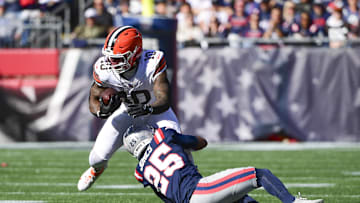 Oct 26, 2025; Foxborough, Massachusetts, USA;  Cleveland Browns running back Quinshon Judkins (10) runs with the ball against New England Patriots cornerback Marcus Jones (25) during the first quarter at Gillette Stadium. Mandatory Credit: Bob DeChiara-Imagn Images