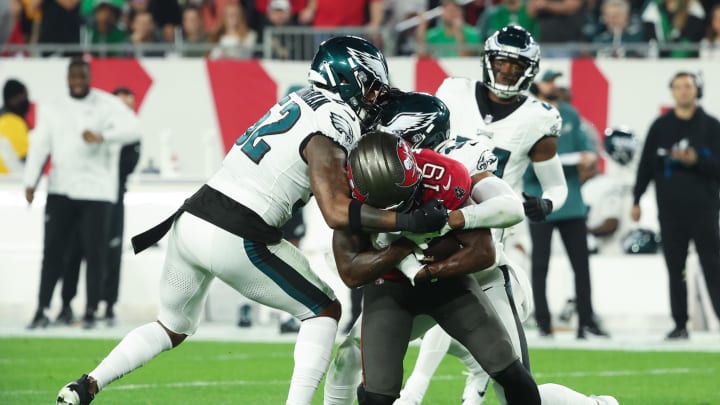 Jan 15, 2024; Tampa, Florida, USA; Tampa Bay Buccaneers wide receiver David Moore (19) is tackled by Philadelphia Eagles linebacker Zach Cunningham (52) and safety Kevin Byard (31) during the first half of a 2024 NFC wild card game at Raymond James Stadium. Mandatory Credit: Kim Klement Neitzel-USA TODAY Sports