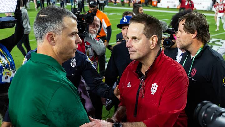 Jan 19, 2026; Miami Gardens, FL, USA; Indiana Hoosiers head coach Curt Cignetti (right) greets Miami Hurricanes head coach Mario Cristobal following the College Football Playoff National Championship game at Hard Rock Stadium. Mandatory Credit: Mark J. Rebilas-Imagn Images