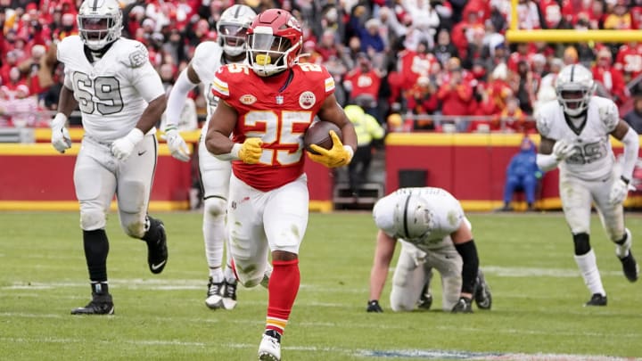 Dec 25, 2023; Kansas City, Missouri, USA; Kansas City Chiefs running back Clyde Edwards-Helaire (25) runs the ball against the Las Vegas Raiders during the game at GEHA Field at Arrowhead Stadium. Mandatory Credit: Denny Medley-USA TODAY Sports