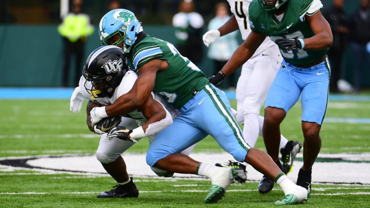 Nov 12, 2022; New Orleans, Louisiana, USA; Tulane Green Wave linebacker Jesus Machado (35) tackles UCF Knights running back RJ Harvey (22) during the second quarter at Yulman Stadium. 