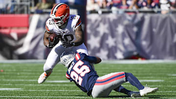 Oct 26, 2025; Foxborough, Massachusetts, USA;  Cleveland Browns running back Quinshon Judkins (10) runs with the ball against New England Patriots cornerback Marcus Jones (25) during the first quarter at Gillette Stadium. Mandatory Credit: Bob DeChiara-Imagn Images