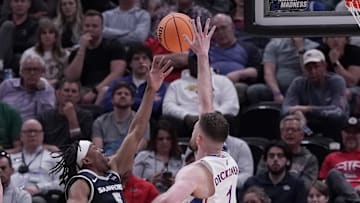 Mar 21, 2024; Salt Lake City, UT, USA; Samford Bulldogs guard A.J. Staton-McCray (5) shoots against Kansas Jayhawks center Hunter Dickinson (1) during the second half in the first round of the 2024 NCAA Tournament at Vivint Smart Home Arena-Delta Center. Mandatory Credit: Gabriel Mayberry-Imagn Images