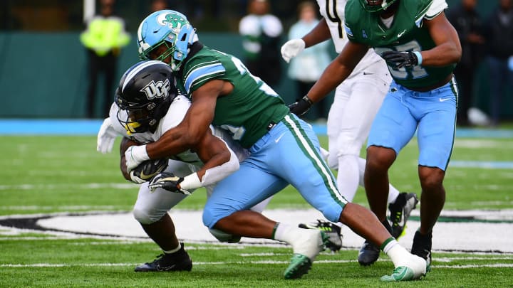 Nov 12, 2022; New Orleans, Louisiana, USA; Tulane Green Wave linebacker Jesus Machado (35) tackles UCF Knights running back RJ Harvey (22) during the second quarter at Yulman Stadium. 