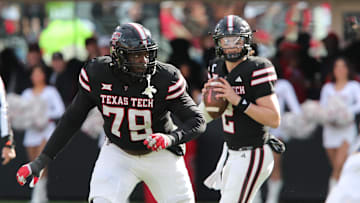 Nov 30, 2024; Lubbock, Texas, USA;  Texas Tech Red Raiders offensive guard Sterling Porcher (79) blocks for quarterback Behren Morton (2) in the second half during the game against the West Virginia Mountaineers at Jones AT&T Stadium and Cody Campbell Field. Mandatory Credit: Michael C. Johnson-Imagn Images
