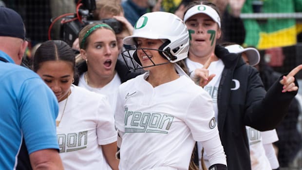 Oregon’s Kedre Luschar, center, celebrates her home run against Stanford during the Eugene NCAA Softball Regional May 18, 202