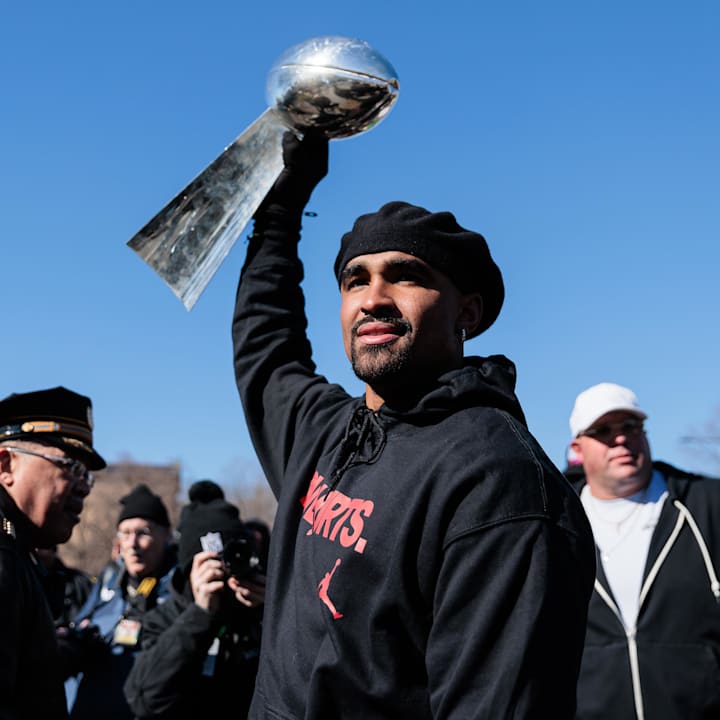 Philadelphia Eagles quarterback Jalen Hurts (1) raises the Lombardi Trophy during the Super Bowl LIX championship parade.