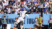 Sep 14, 2025; Nashville, Tennessee, USA; Tennessee Titans wide receiver Elic Ayomanor (5) makes a catch over Los Angeles Rams cornerback Emmanuel Forbes Jr. (1) during the first half at Nissan Stadium. Mandatory Credit: Steve Roberts-Imagn Images