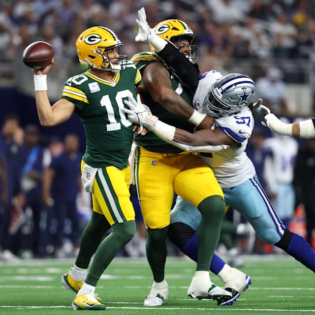 Green Bay Packers quarterback Jordan Love (10) throws a pass against Dallas Cowboys defensive tackle Osa Odighizuwa.