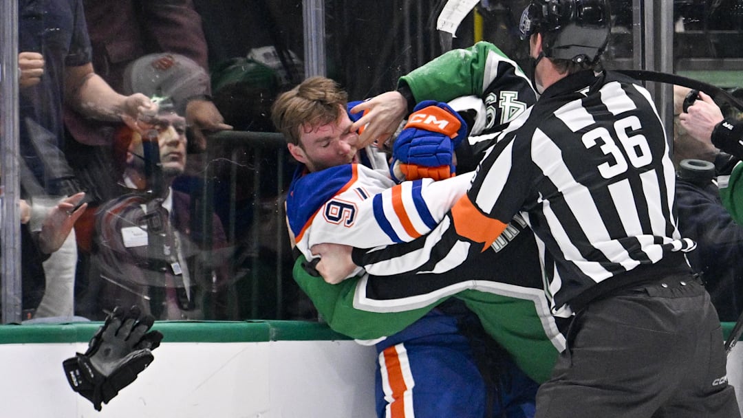 Mar 12, 2026; Dallas, Texas, USA; Dallas Stars center Justin Hryckowian (49) fights Edmonton Oilers center Connor McDavid (97) during the second period at the American Airlines Center. Mandatory Credit: Jerome Miron-Imagn Images