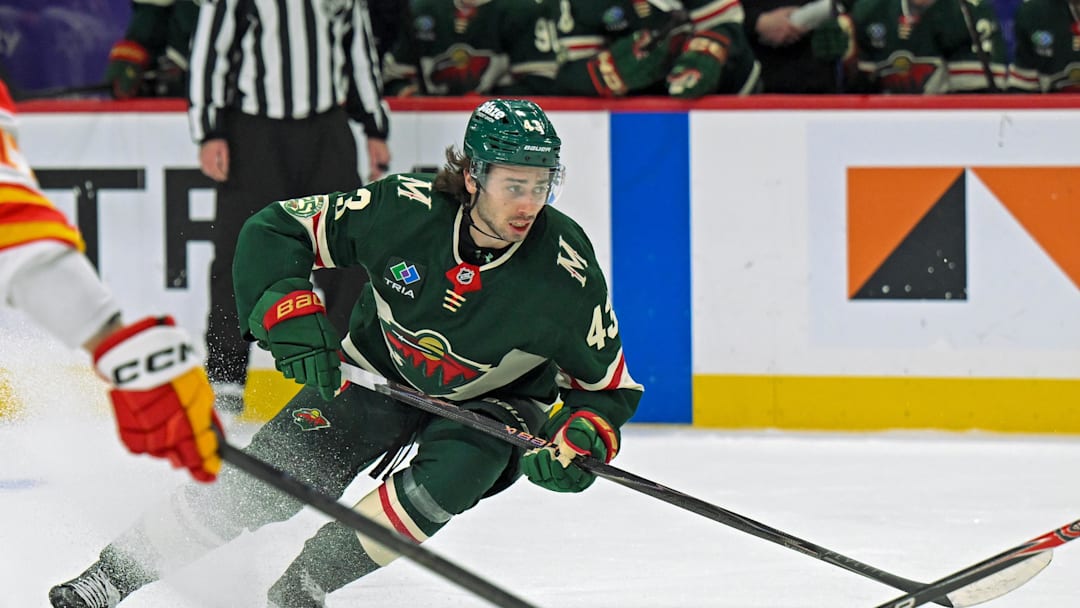 Jan 29, 2026; Saint Paul, Minnesota, USA;  Minnesota Wild defensemen Quinn Hughes (43) controls the puck against the Calgary Flames during the second period at Grand Casino Arena. Mandatory Credit: Nick Wosika-Imagn Images
