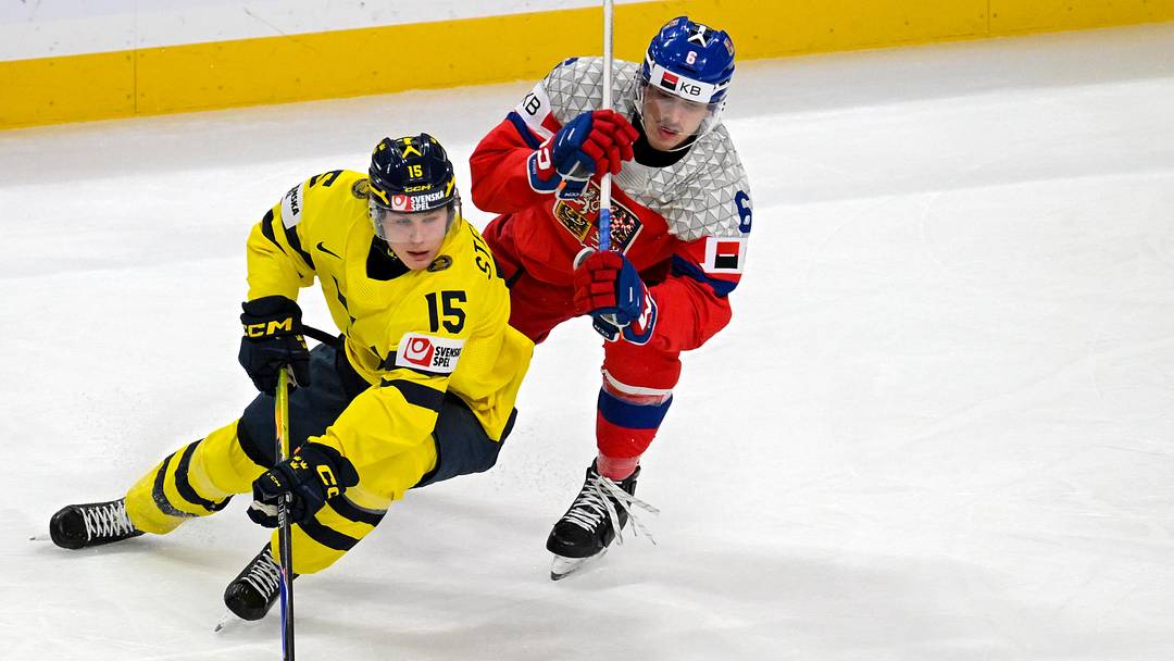 Jan 5, 2026; St. Paul, Minnesota, USA; Sweden forward Ivar Stenberg (15) controls the puck as Czechia defenseman Radim Mrtka (6) gives chase during the first period in the final of the 2026 IIHF World Junior Championship ice hockey tournament at Grand Casino Arena. Mandatory Credit: Nick Wosika-Imagn Images