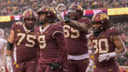 Nov 25, 2023; Minneapolis, Minnesota, USA;  Minnesota Golden Gophers wide receiver Daniel Jackson (9) celebrates his 7-yard touchdown reception against the Wisconsin Badgers with offensive lineman Tyler Cooper (75), offensive lineman Aireontae Ersery (69), and running back Jordan Nubin (30) during the second quarter at Huntington Bank Stadium. Mandatory Credit: Nick Wosika-USA TODAY Sports