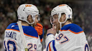 Jan 15, 2025; Saint Paul, Minnesota, USA;  Edmonton Oilers forward Leon Draisaitl (29) and forward Connor McDavid (97) talk before a face-off against the Minnesota Wild during the third period at Xcel Energy Center. Mandatory Credit: Nick Wosika-Imagn Images

