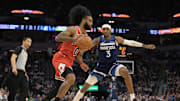 Feb 5, 2025; Minneapolis, Minnesota, USA; Chicago Bulls guard Coby White (0) drives to the basket as Minnesota Timberwolves forward Jaden McDaniels (3) defends during the second quarter at Target Center. Mandatory Credit: Nick Wosika-Imagn Images