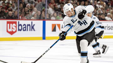 Dec 20, 2024; Saint Paul, Minnesota, USA;  Utah Hockey Club forward Nick Bjugstad (17) takes a shot on goal against the Minnesota Wild during the third period at Xcel Energy Center. Mandatory Credit: Nick Wosika-Imagn Images
