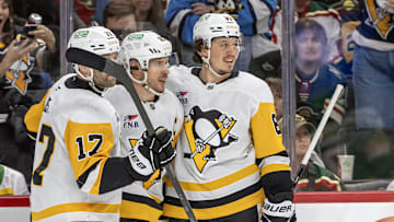 Mar 9, 2025; Saint Paul, Minnesota, USA;  Pittsburgh Penguins forward Sidney Crosby (87) celebrates his empty net goal with forward Bryan Rust (17) and forward Rickard Rakell (67) during the third period at Xcel Energy Center. Mandatory Credit: Nick Wosika-Imagn Images