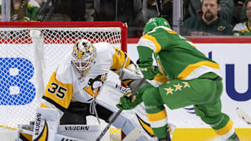 Mar 9, 2025; Saint Paul, Minnesota, USA;  Pittsburgh Penguins goalie Tristan Jarry (35) makes a save on Minnesota Wild defenseman Brock Faber (7) during the first period at Xcel Energy Center. Mandatory Credit: Nick Wosika-Imagn Images