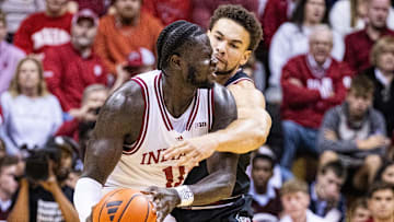 Nov 16, 2024; Bloomington, Indiana, USA; Indiana Hoosiers center Oumar Ballo (11) dribbles the ball while South Carolina Gamecocks guard Arden Conyers (21) defends in the second half at Simon Skjodt Assembly Hall. Mandatory Credit: Trevor Ruszkowski-Imagn Images