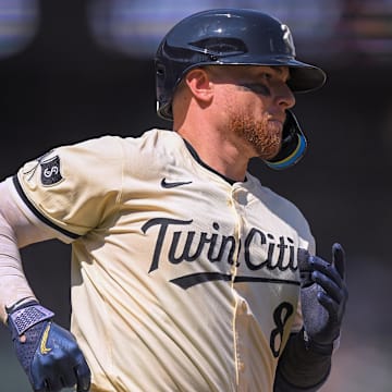 Jul 13, 2025; Minneapolis, Minnesota, USA; Minnesota Twins catcher Christian Vazquez (8) heads to first on a single against the Pittsburgh Pirates during the eighth inning at Target Field. Mandatory Credit: Nick Wosika-Imagn Images