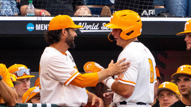 Jun 22, 2024; Omaha, NE, USA; Tennessee Volunteers head coach Tony Vitello talks with left fielder Dylan Dreiling (8) after a run scored against the Texas A&M Aggies during the second inning at Charles Schwab Field Omaha. Mandatory Credit: Dylan Widger-USA TODAY Sports