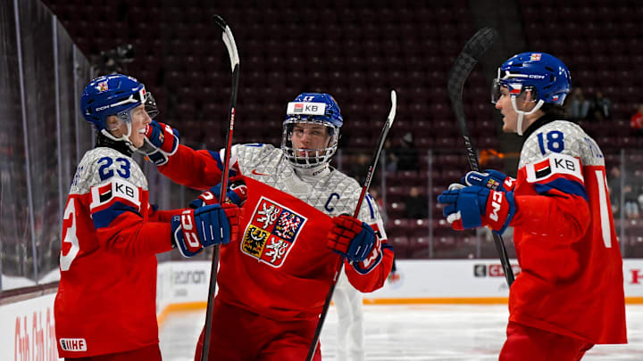 Jan 2, 2026; Minneapolis, Minnesota, USA; Czechia defensemen Tomas Galvas (23) celebrates his goal against Switzerland with forward Petr Sikora (17) and forward Tomas Poletin (18) during the second period in the quarterfinals of the 2026 IIHF World Junior Championship at 3M Arena. Mandatory Credit: Nick Wosika-Imagn Images