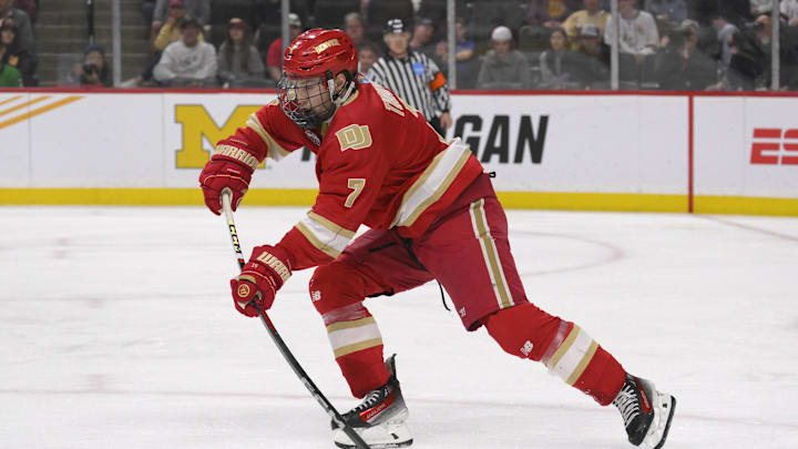 Apr 13, 2024; Saint Paul, Minnesota, USA; Denver Pioneers forward Aidan Thompson (7) makes a pass against the Boston College Eagles during the first period of the championship game of the 2024 Frozen Four college ice hockey tournament at Xcel Energy Center. Mandatory Credit: Nick Wosika-Imagn Images